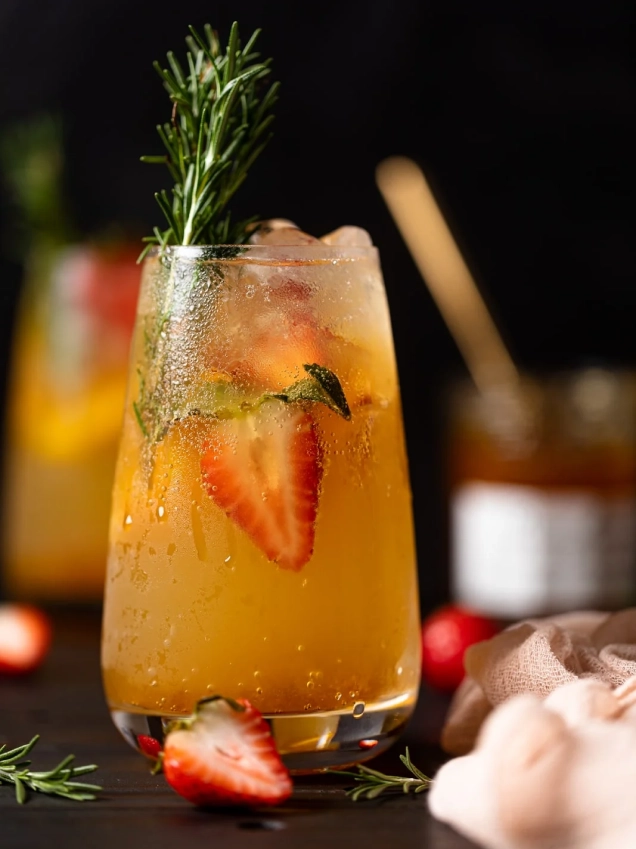 orange mocktail with strawberry garnish